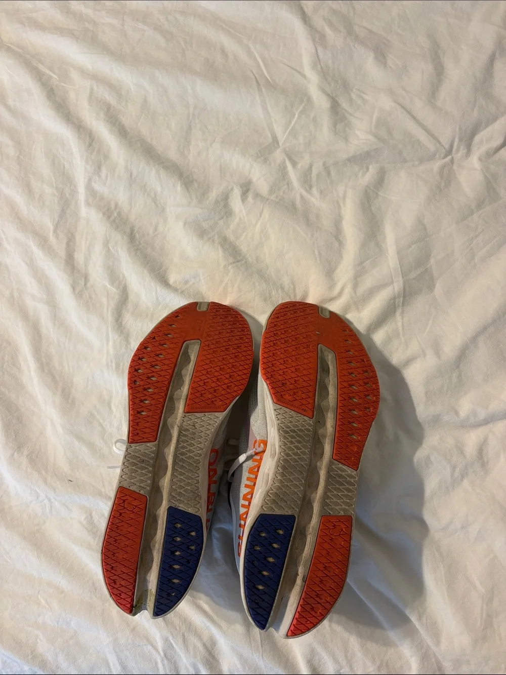 On Running Mens White Sneakers with Orange Accents